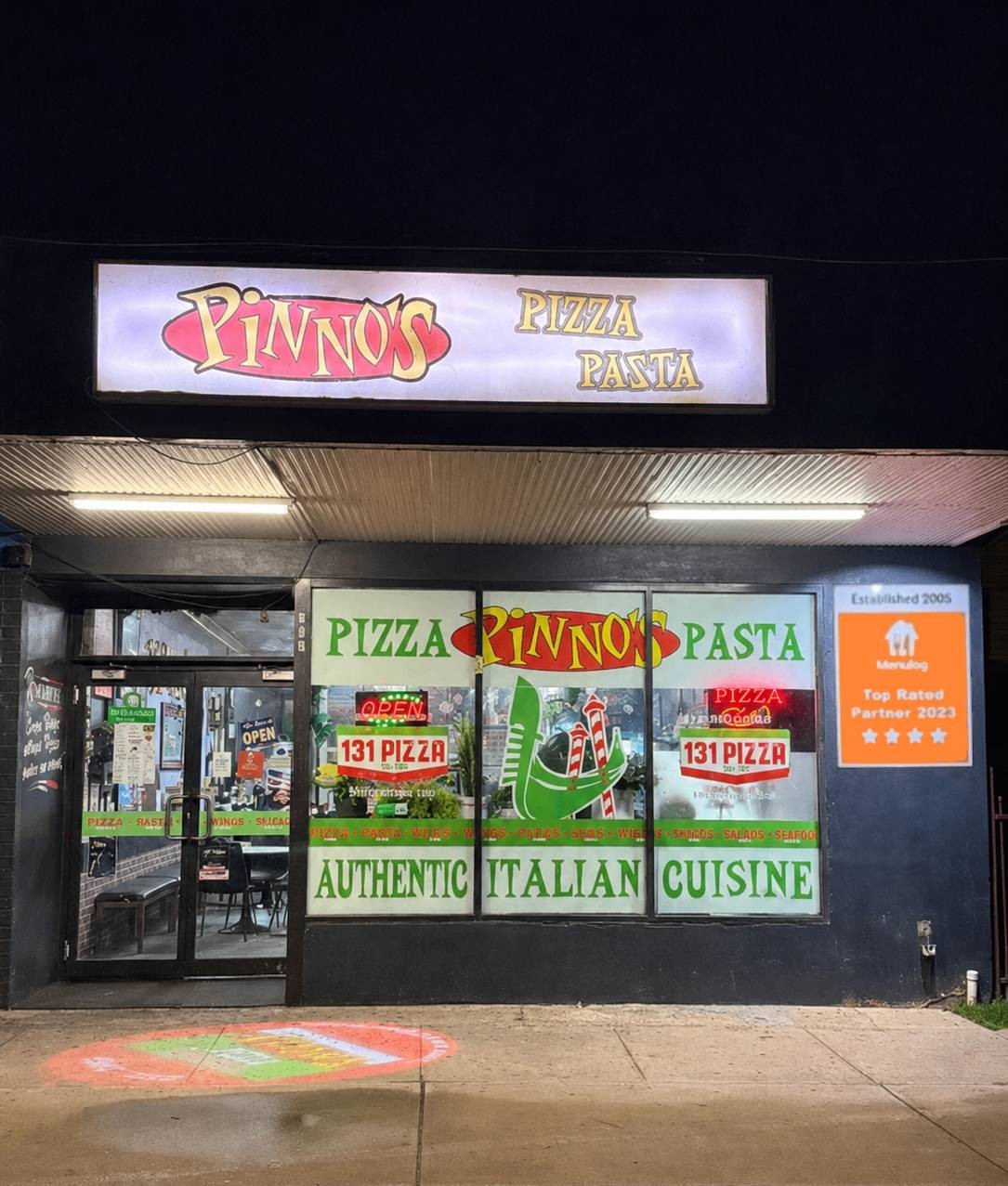 Pinno's Pizza & Pasta shopfront lit up on Deakin Avenue, Mildura, at night